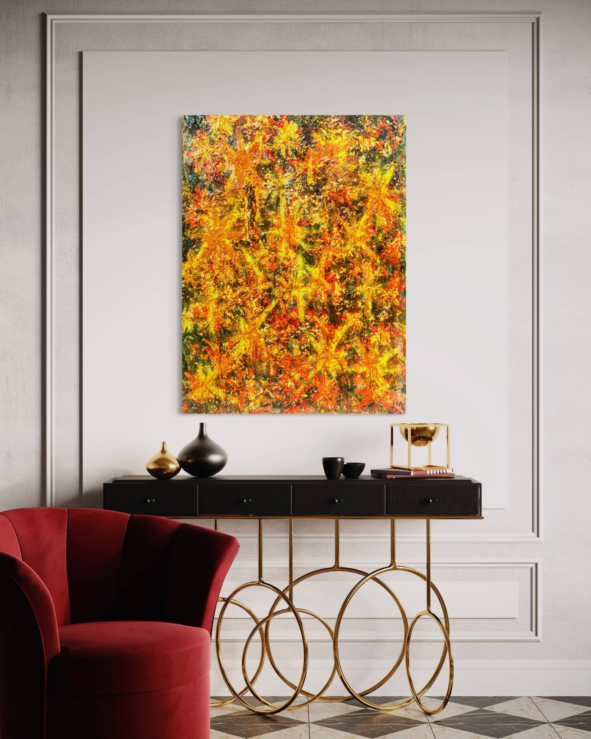 Abstract painting with warm yellows, oranges, and reds on a pale wall above a black console, with a red velvet chair in the foreground.