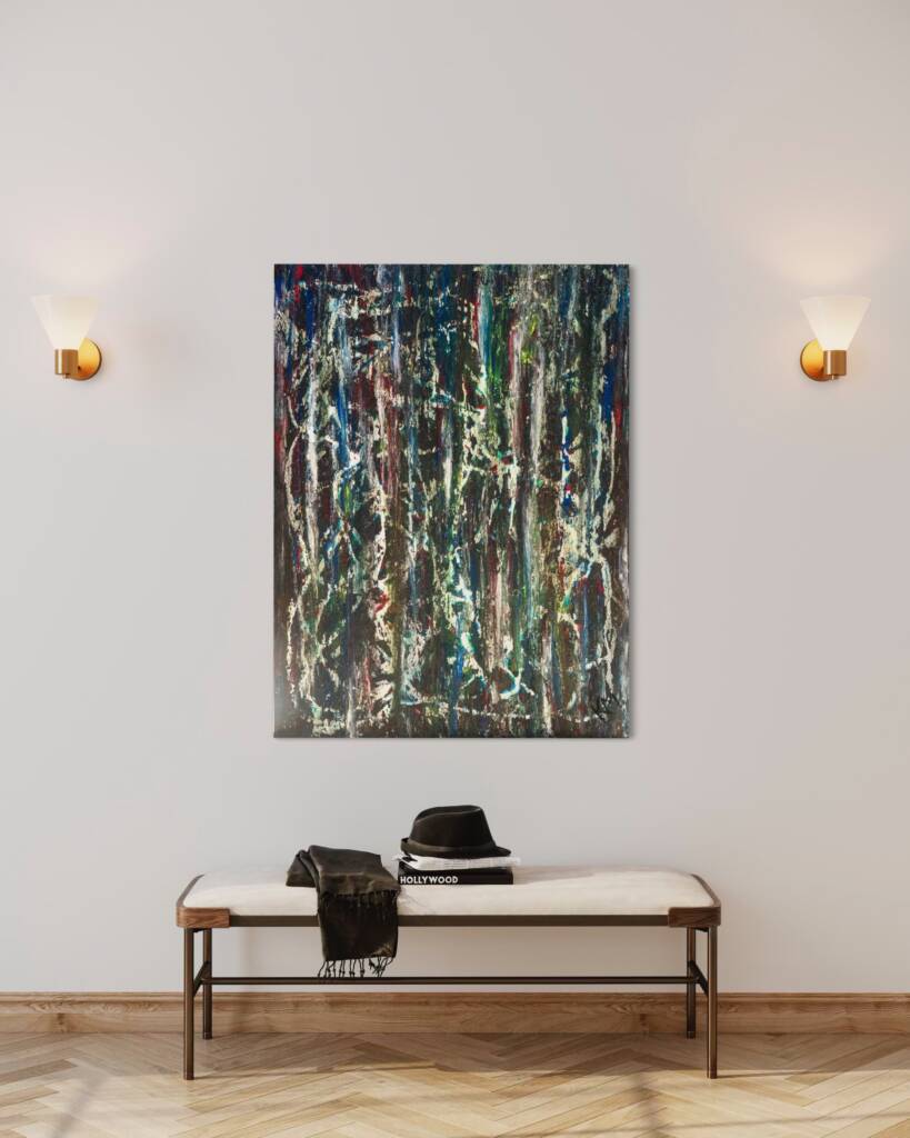 Abstract color-splattered painting on a light wall above a bench with a hat and scarf laid on a magazine-stacked table