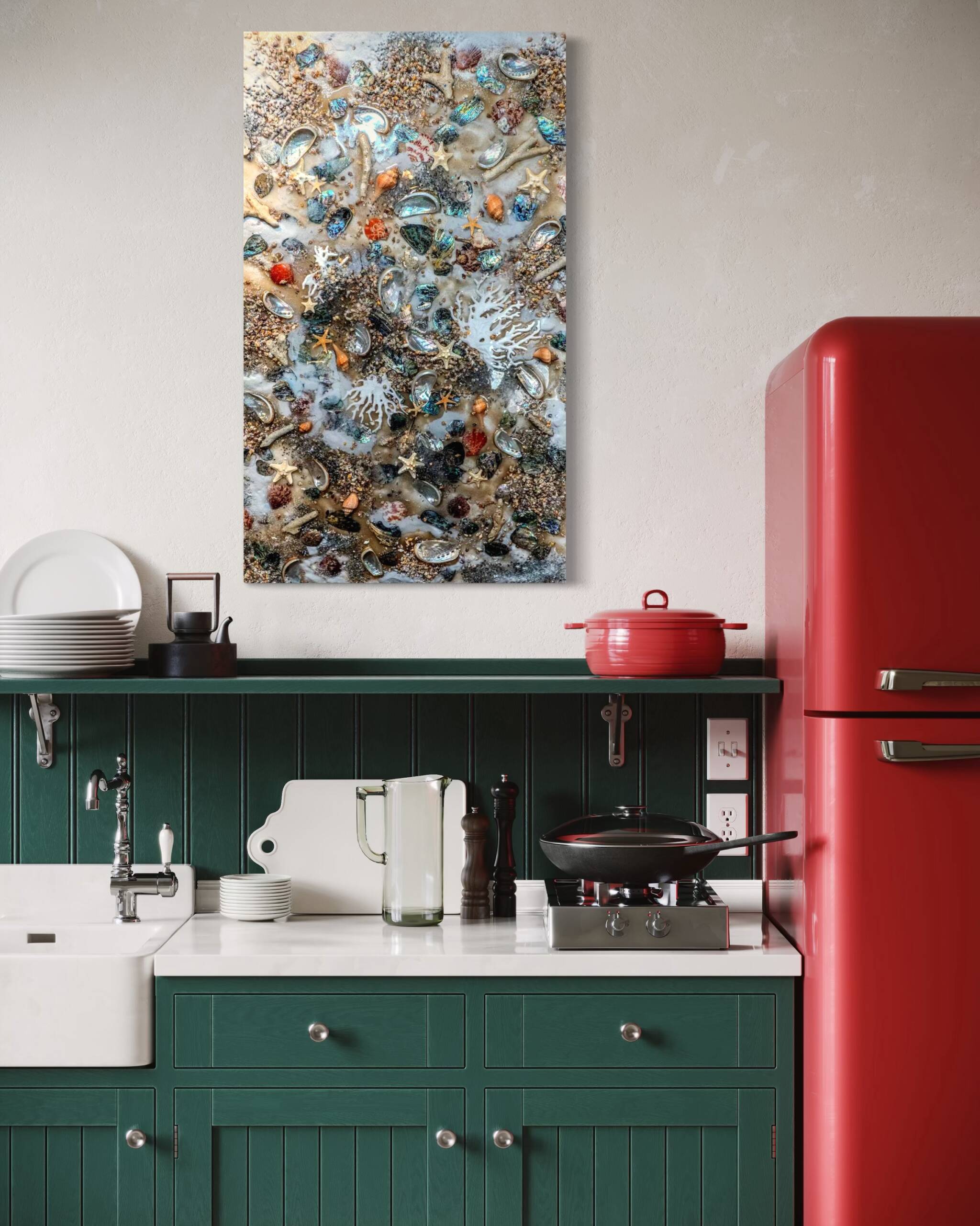 Coastal kitchen with teal cabinets, a red retro fridge, and a wall art piece showing seashells and starfish above the countertop.